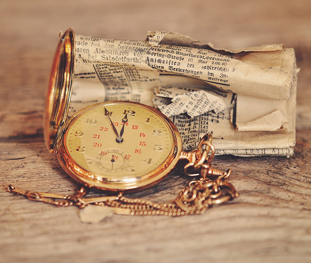 pocketwatch and old newspaper