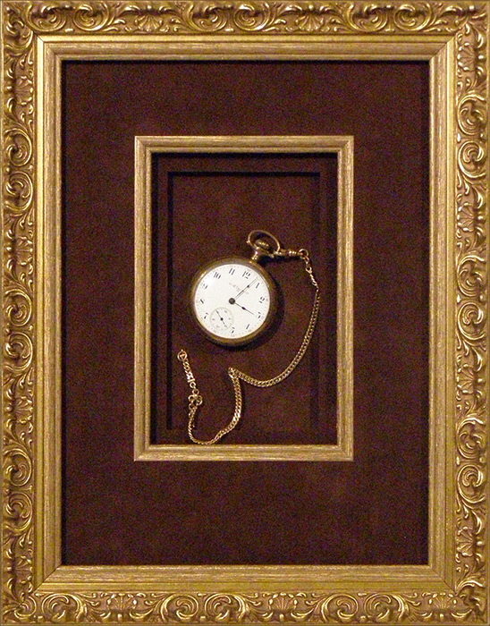 ornate frame with pocket watch