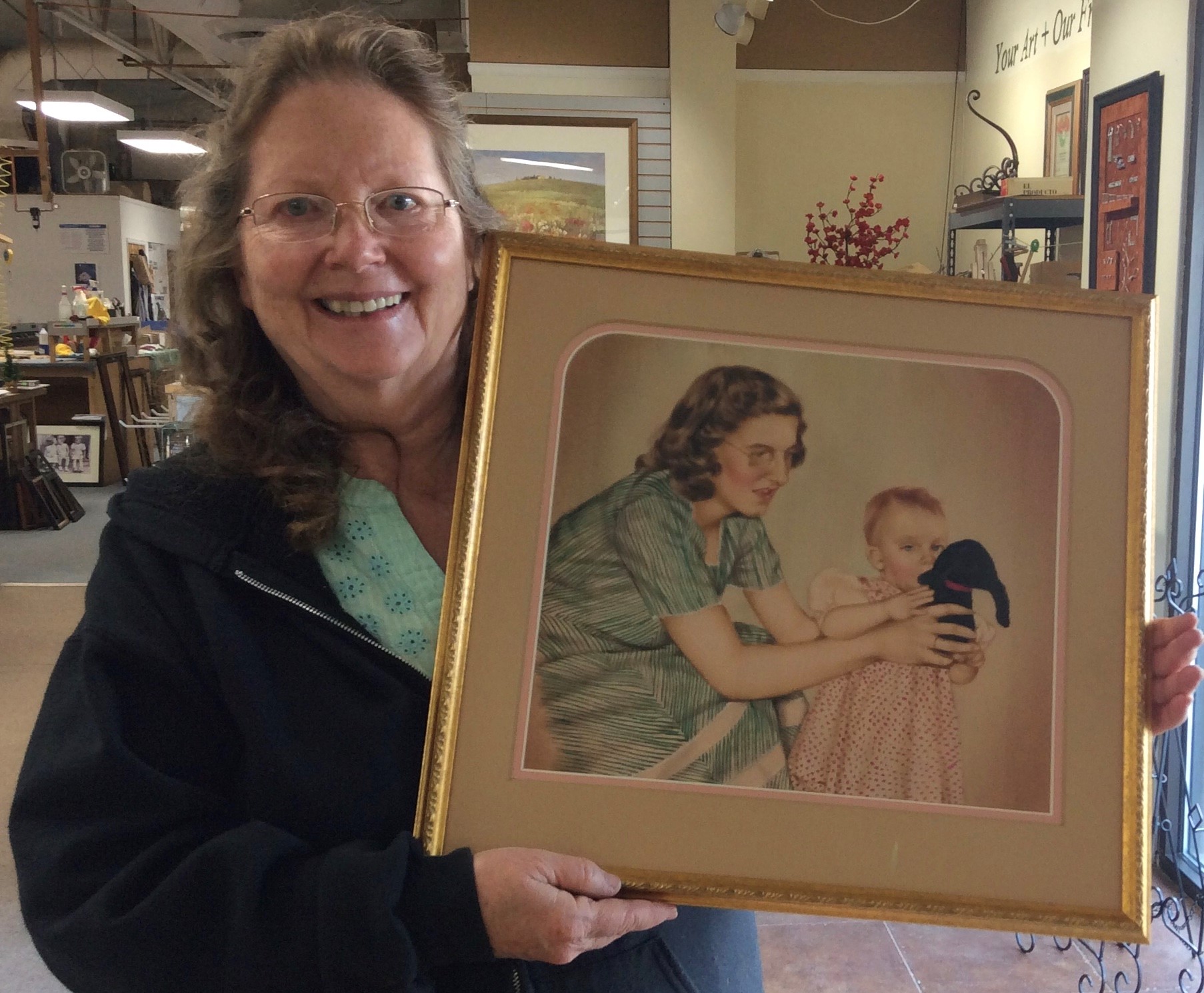 Jan showing framed drawing of mother and girl