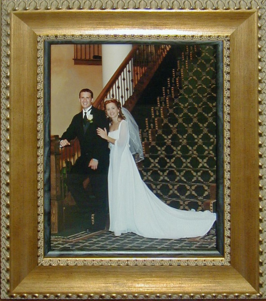 gold frames around wedding photos