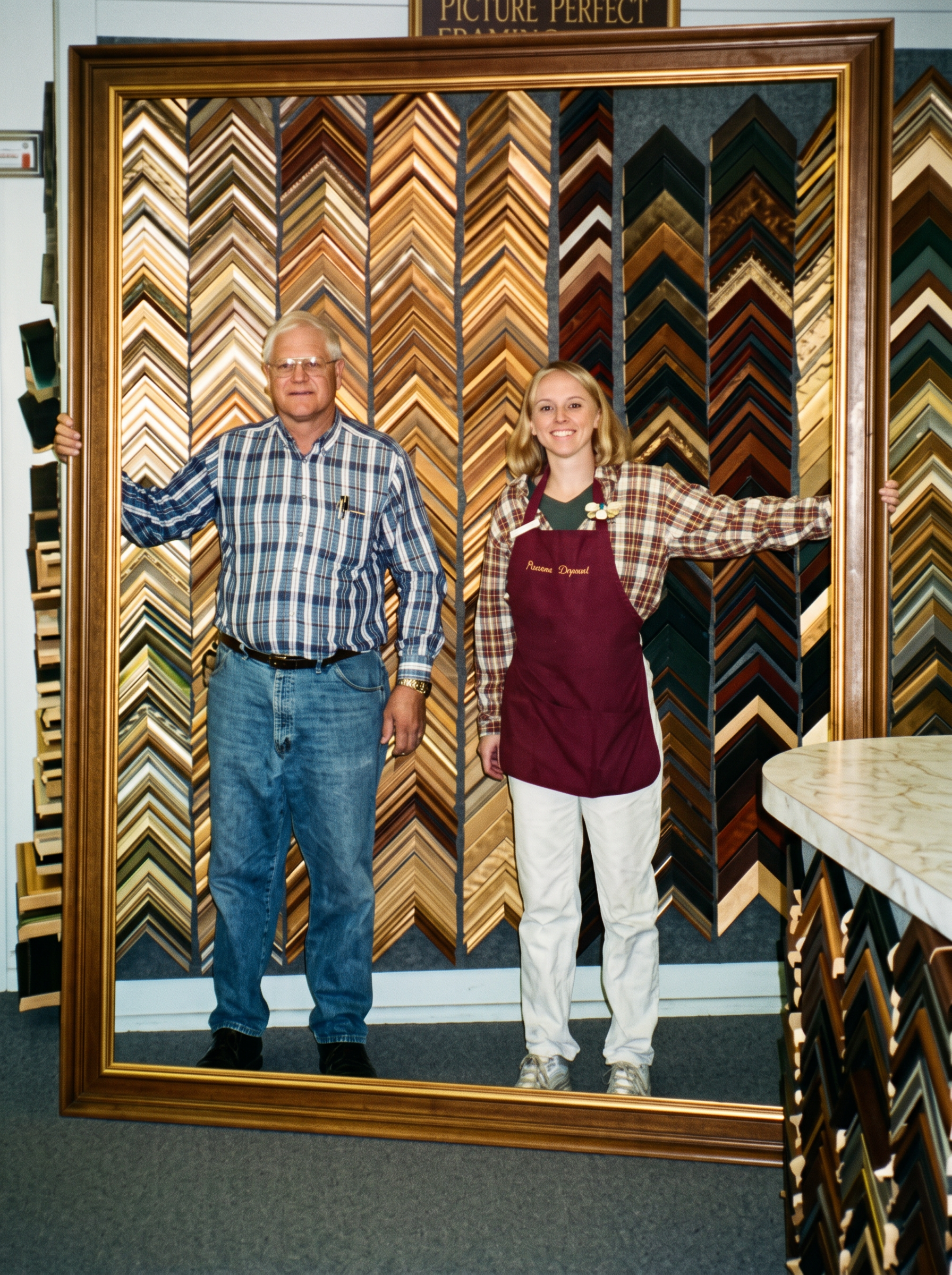 Randy Bogart and his daughter, Claudine, standing in a giant frame.